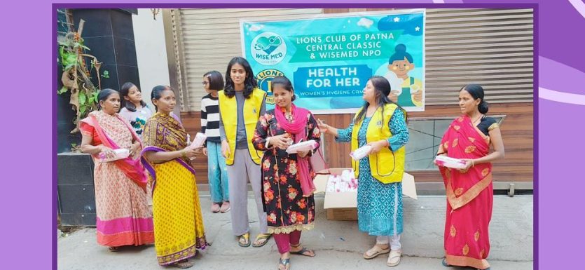 Volunteers distributing free menstrual products to women on the street in Patna