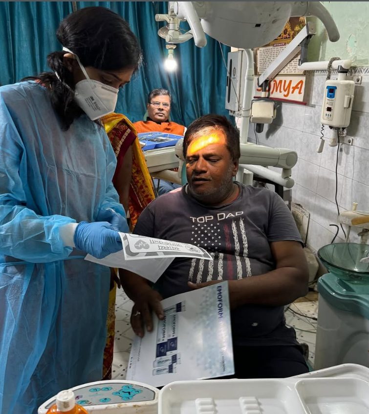A WiseMed volunteer explaining a health awareness flier to a patient