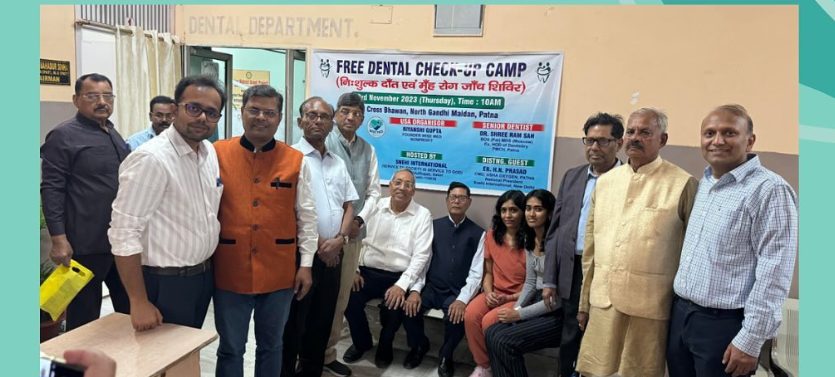 The WiseMed and partner team photographed in front of the camp banner
