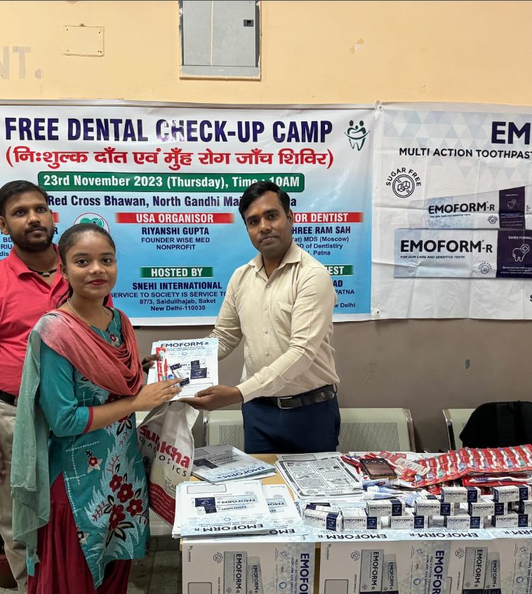 Volunteers handing out dental hygiene supplies at a WiseMed camp